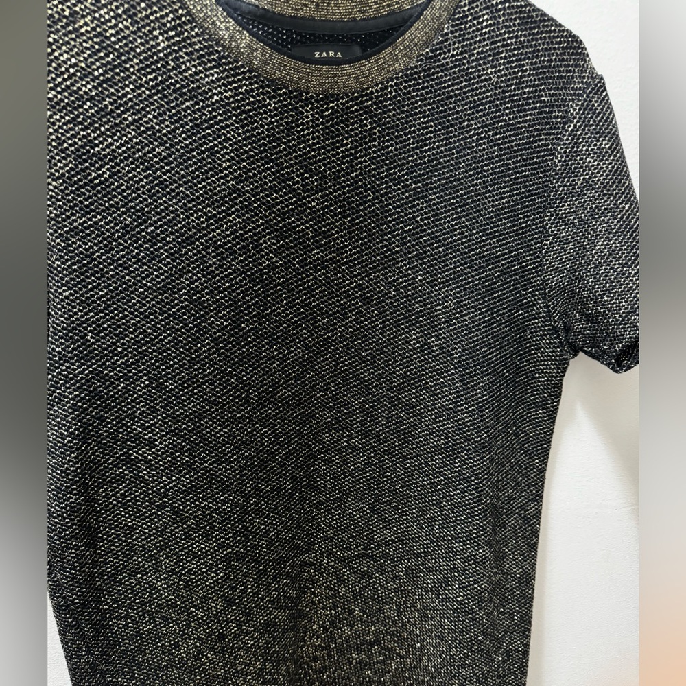 Black and gold shiny tshirt.